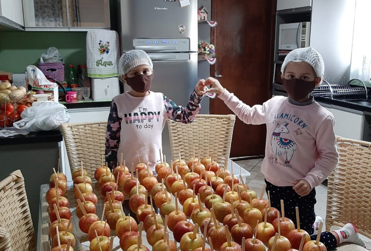 Gêmeas comercializam maçãs do amor para ajudar bebê que precisa de tratamento de saúde